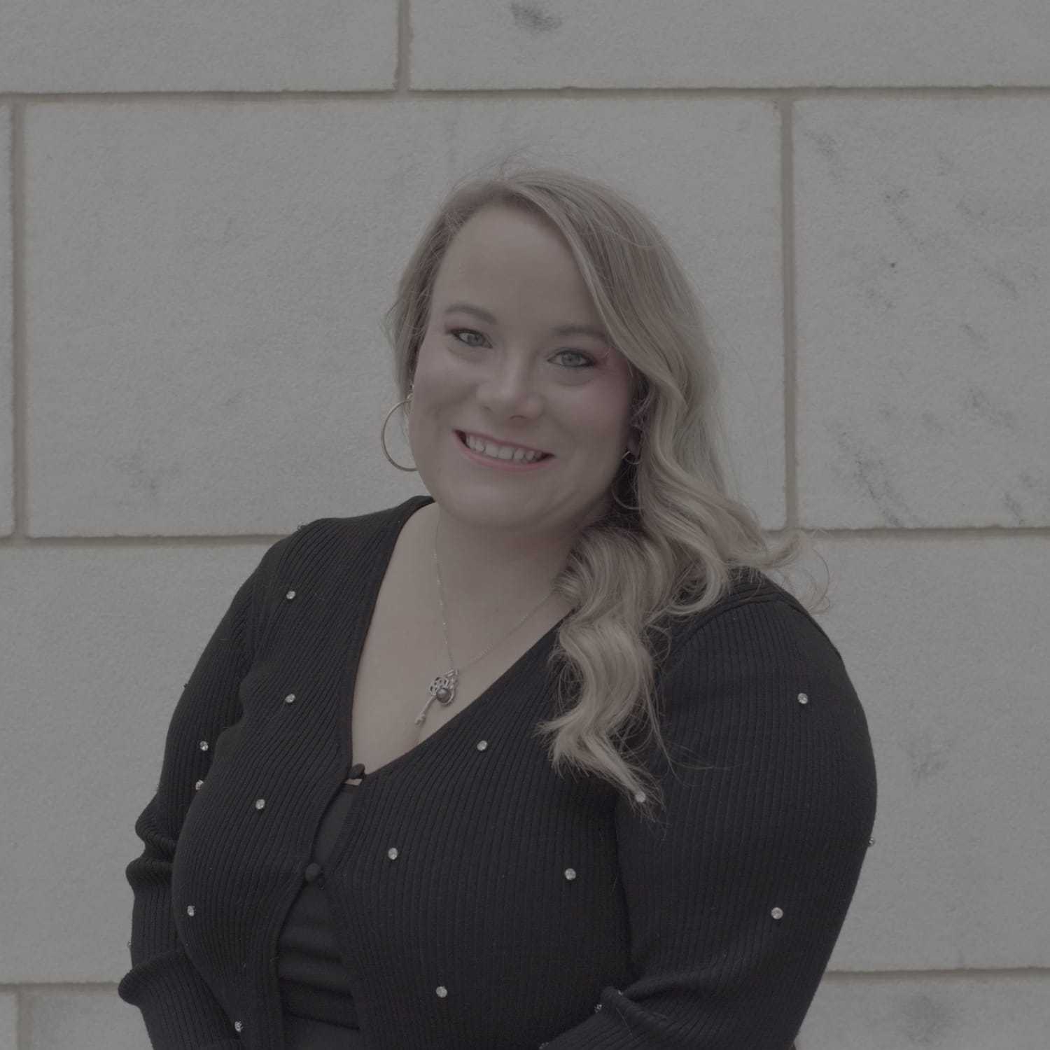 Portrait of Lora, a professional stylist at Cenergi Salon & Boutique, showcasing their expertise and style.