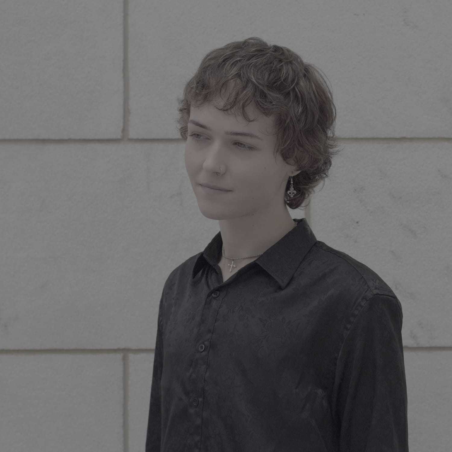 Portrait of Zay, a professional stylist at Cenergi Salon & Boutique, showcasing their expertise and style.