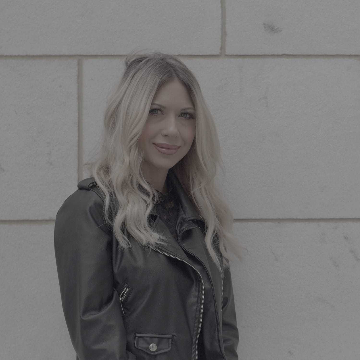 Portrait of Lacy, a professional stylist at Cenergi Salon & Boutique, showcasing their expertise and style.