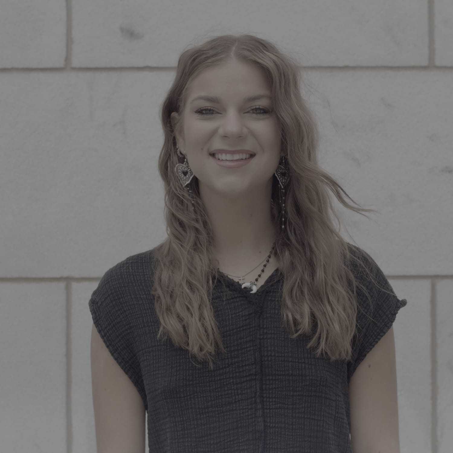 Portrait of Zoe, a professional stylist at Cenergi Salon & Boutique, showcasing their expertise and style.