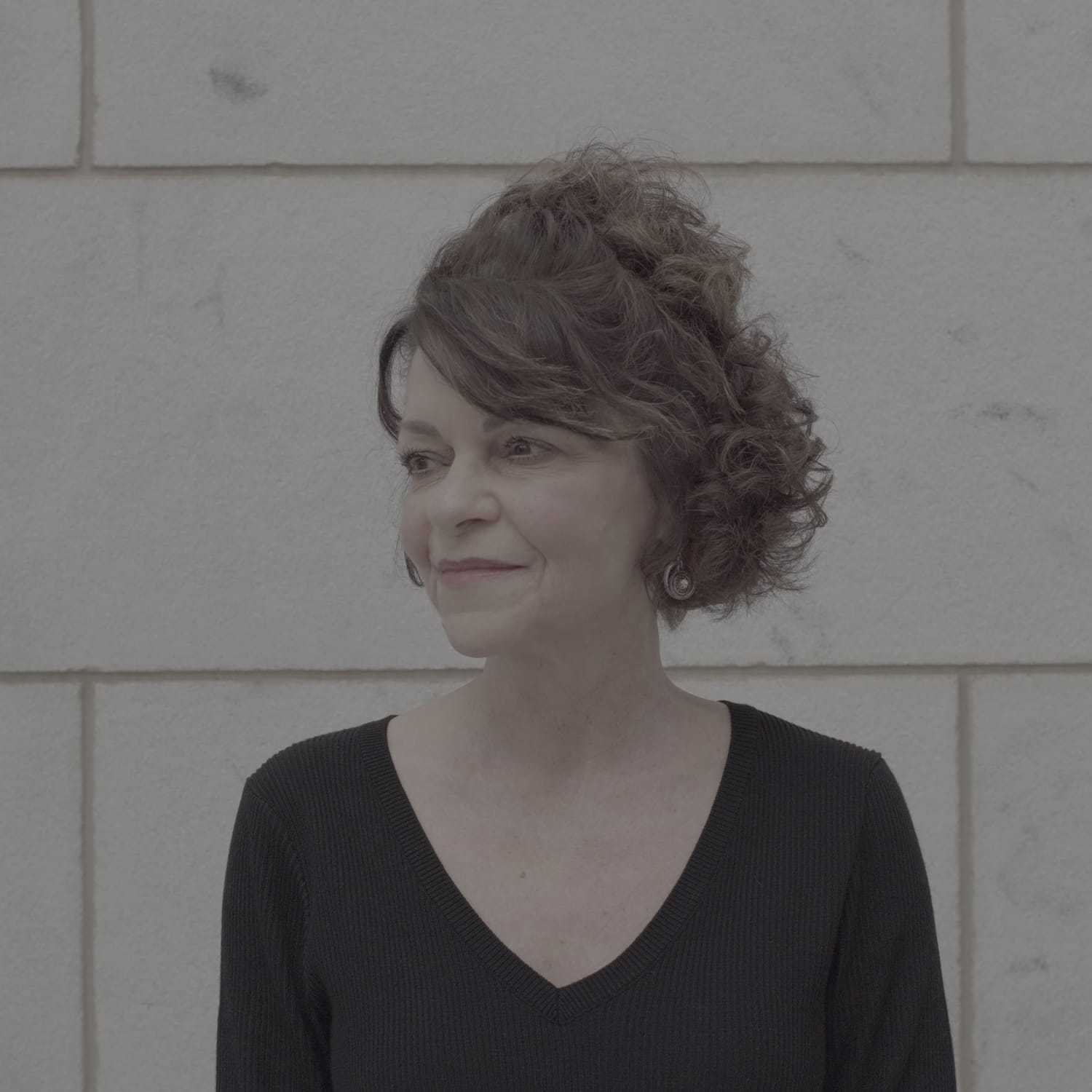 Portrait of Anita, a professional stylist at Cenergi Salon & Boutique, showcasing their expertise and style.