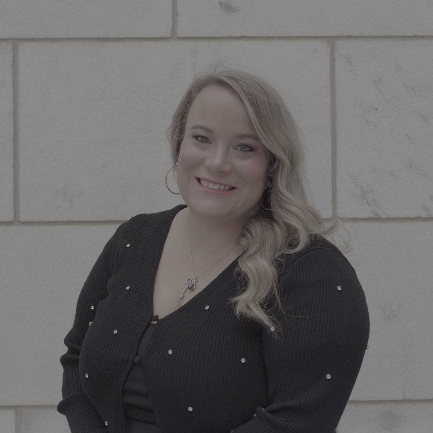 Portrait of Lora, a professional stylist at Cenergi Salon & Boutique, showcasing their expertise and style.