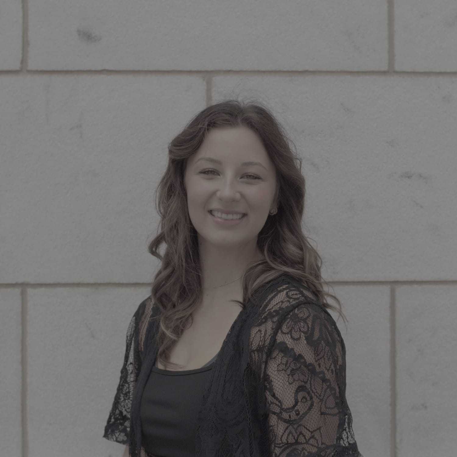 Portrait of Amber, a professional stylist at Cenergi Salon & Boutique, showcasing their expertise and style.